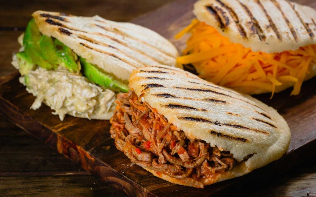 Colombian arepas are oval, smoothed corn tortillas. Locals usually enjoy them alongside cheese, eggs, chicken, and sometimes even broths at any time of day. An authentic Colombian meal is only complete if arepas are there, and it is a must-try when coming to Columbia.